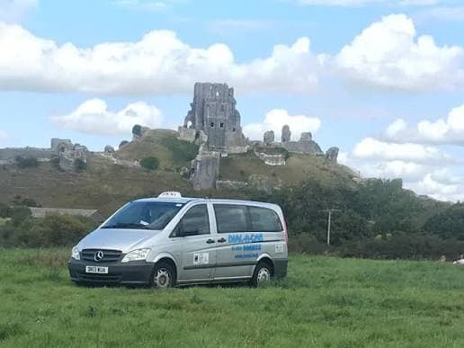 Dial A Cab MPV parked in front of Corfe Castle, Dorset